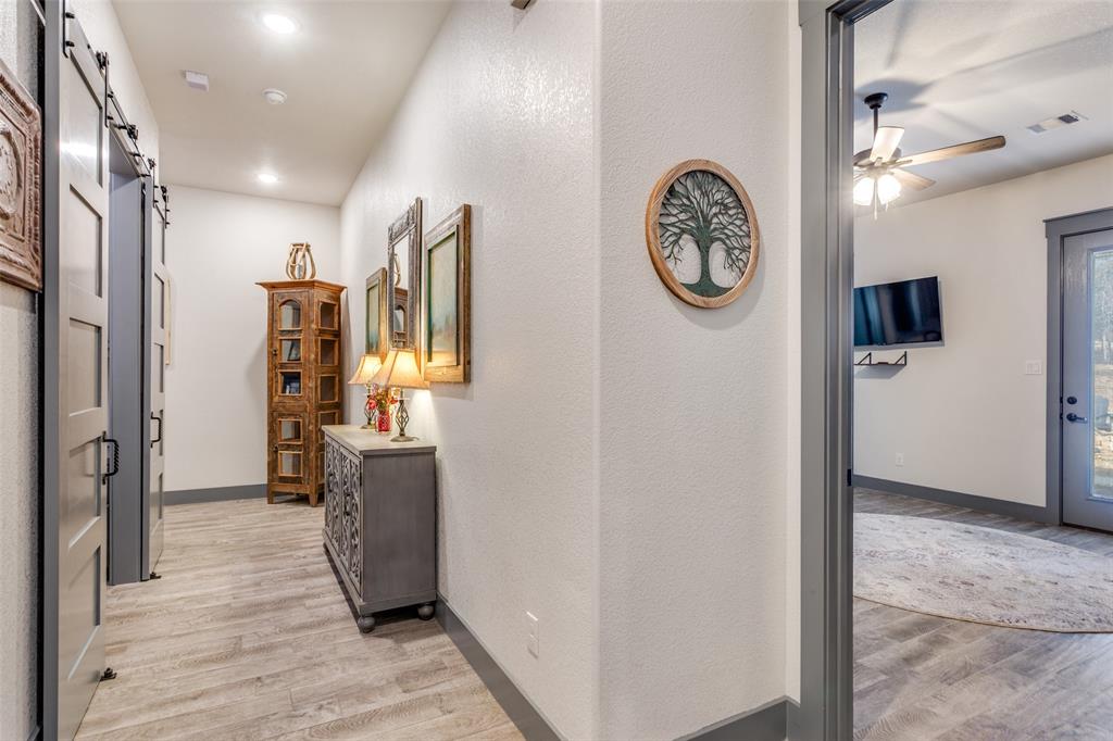 216 Deer Glade Court Azle, TX 76020 - Photo 24 of 40 a view of a hallway with entryway wooden floor and front door