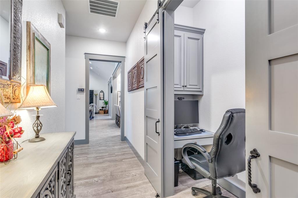 216 Deer Glade Court Azle, TX 76020 - Photo 25 of 40 a view of a hallway with workspace and windows