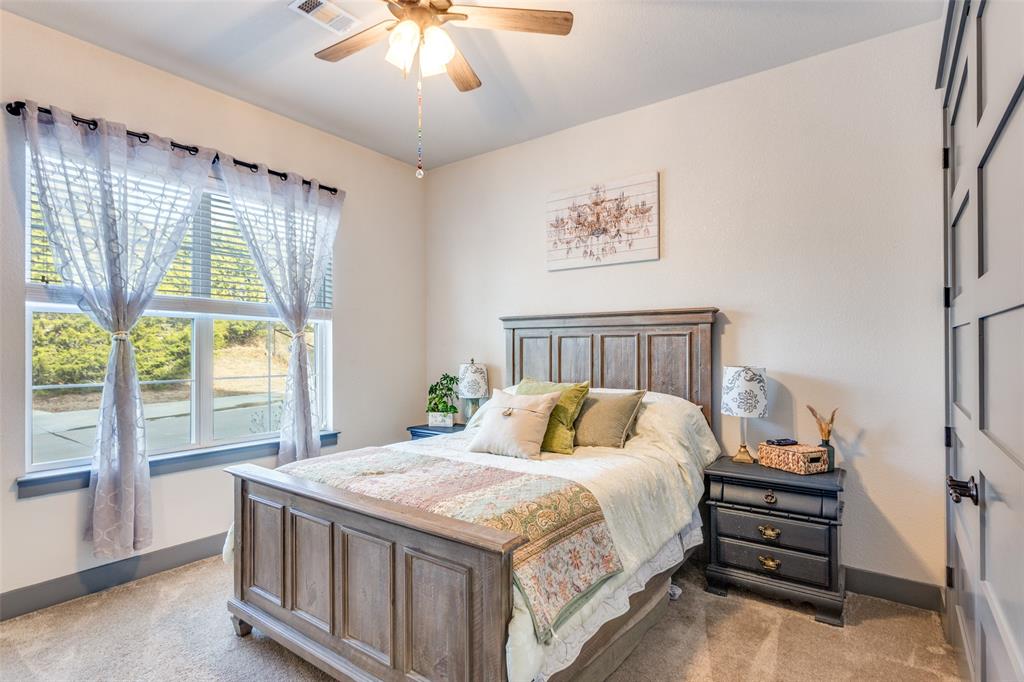 216 Deer Glade Court Azle, TX 76020 - Photo 31 of 40 a bedroom with a bed and a large window