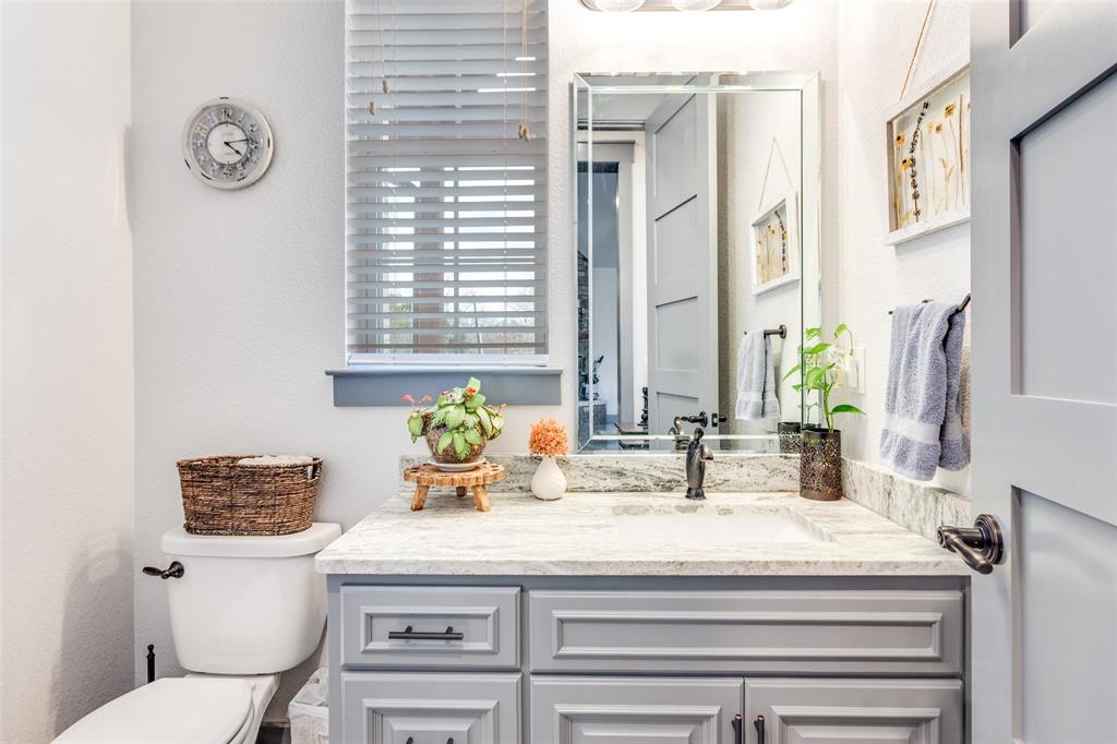 216 Deer Glade Court Azle, TX 76020 - Photo 33 of 40 a bathroom with a granite countertop toilet sink and mirror