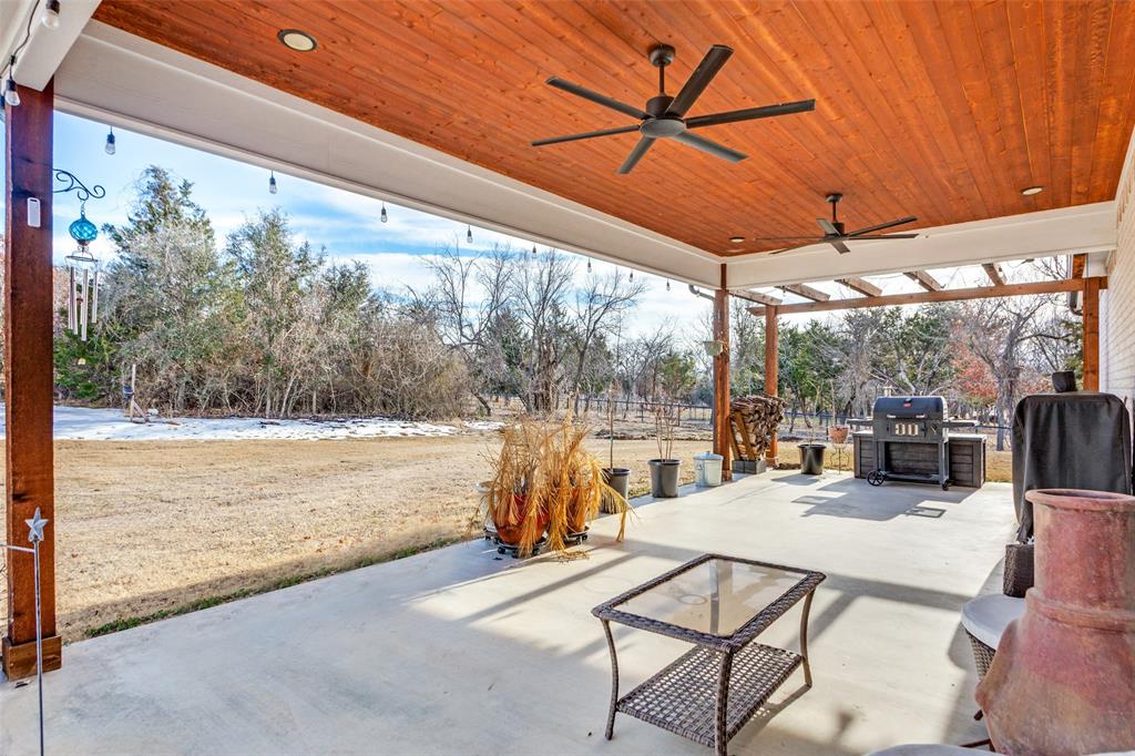216 Deer Glade Court Azle, TX 76020 - Photo 34 of 40 a view of a patio with a table chairs and wooden fence