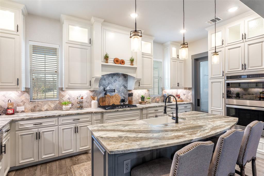 216 Deer Glade Court Azle, TX 76020 - Photo 10 of 40 a kitchen with cabinets a sink appliances and a counter top space