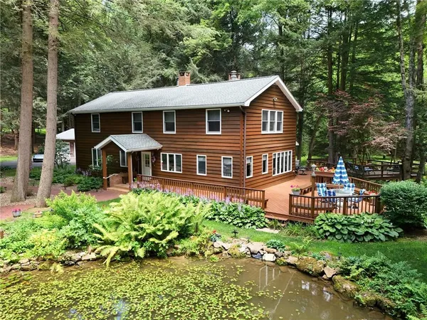a front view of a house with a yard table and chairs