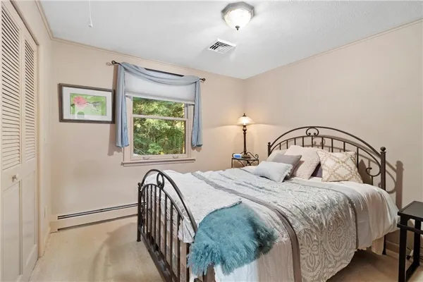 a bathroom with a granite countertop sink mirror and toilet