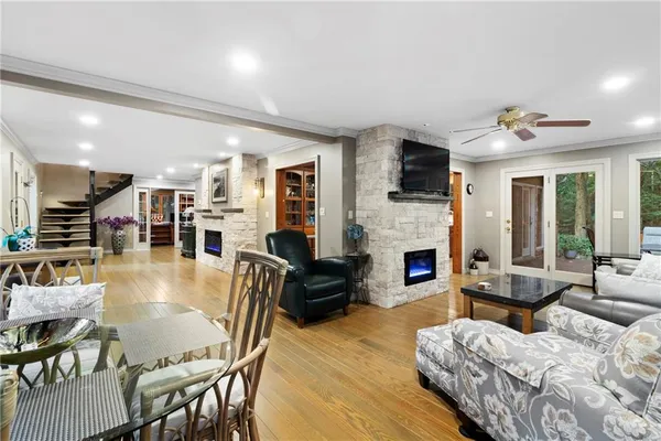 a living room with furniture fireplace and flat screen tv