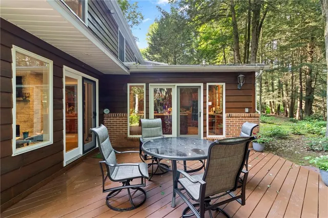 a view of a chairs and table on the wooden deck