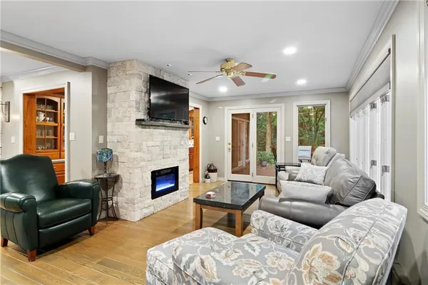 a living room with furniture a flat screen tv and a fireplace