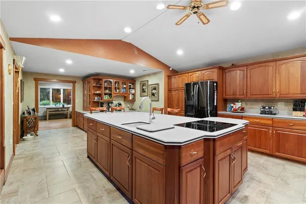 a kitchen with stainless steel appliances granite countertop a sink counter space cabinets and a stove