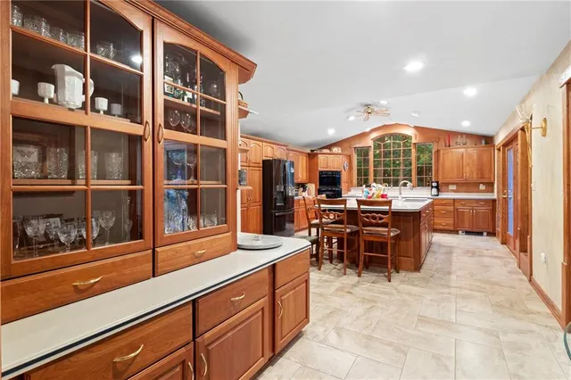 a kitchen with granite countertop a refrigerator and a sink