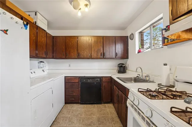 a kitchen with a stove sink and cabinets
