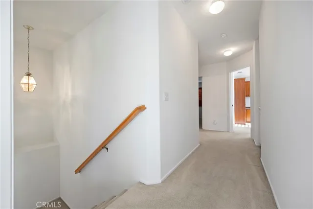 a view of a hallway with stairs