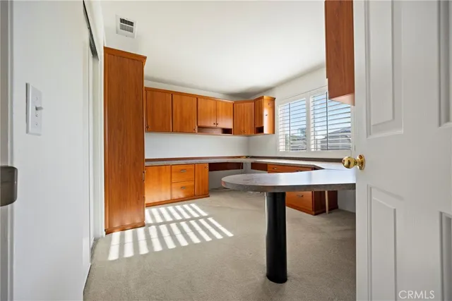 a room with table chair and a refrigerator