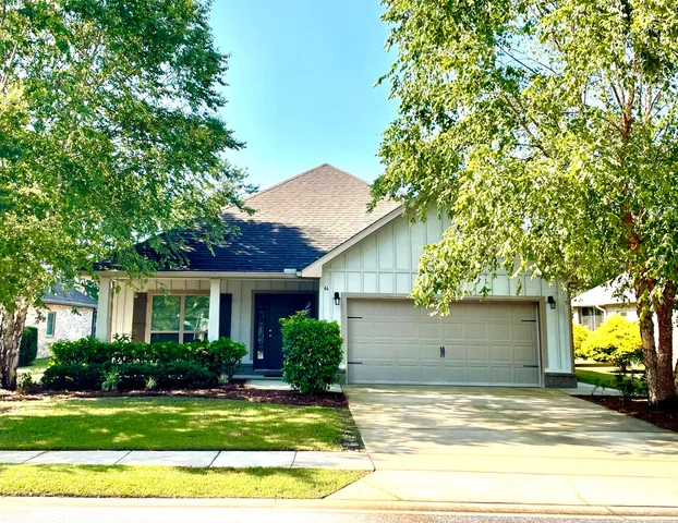 a view of a house with a yard and garage