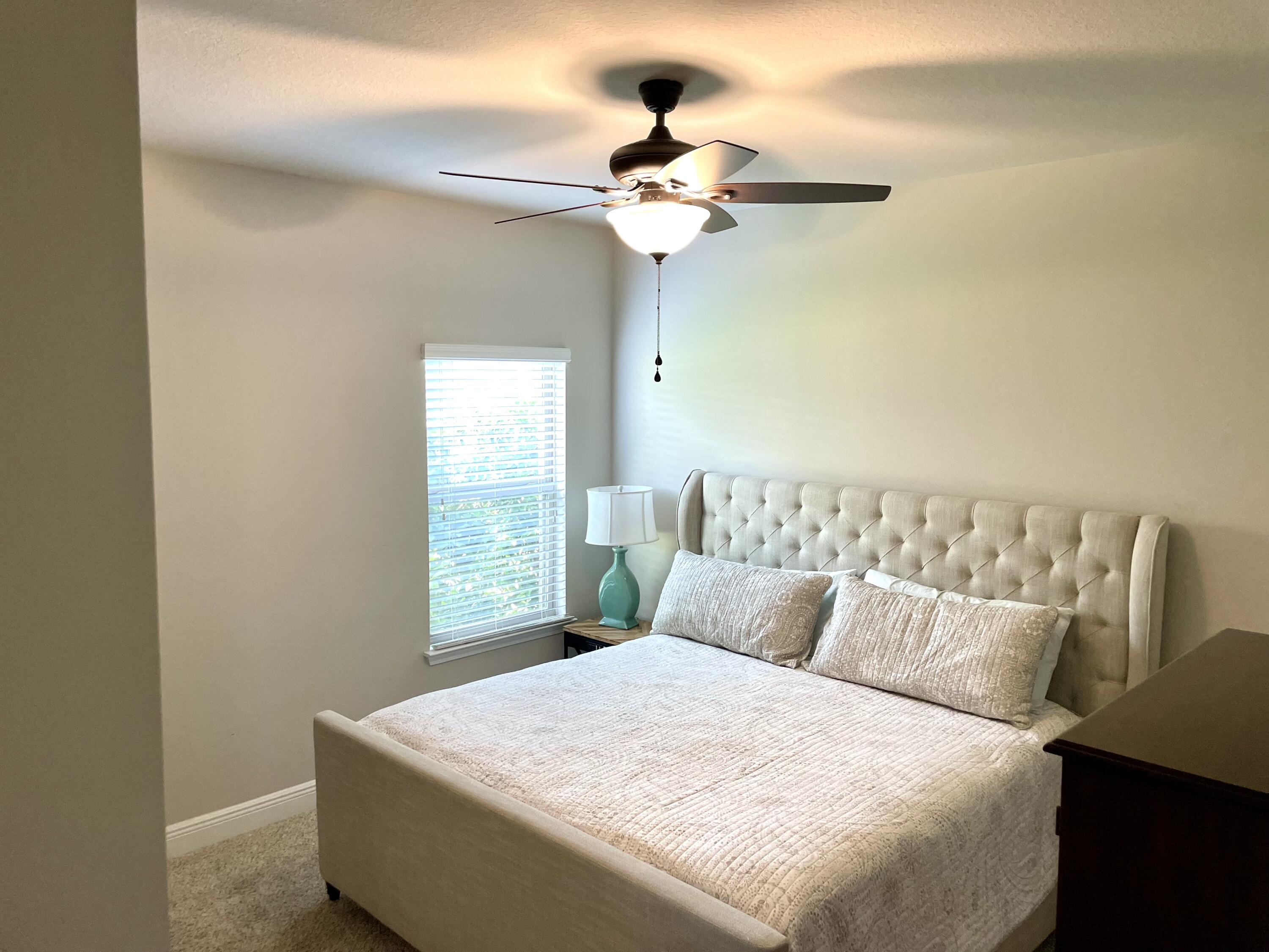 46 Hemingway Lane Freeport, FL 32439 - Photo 19 of 27 a bedroom with a bed and a chandelier