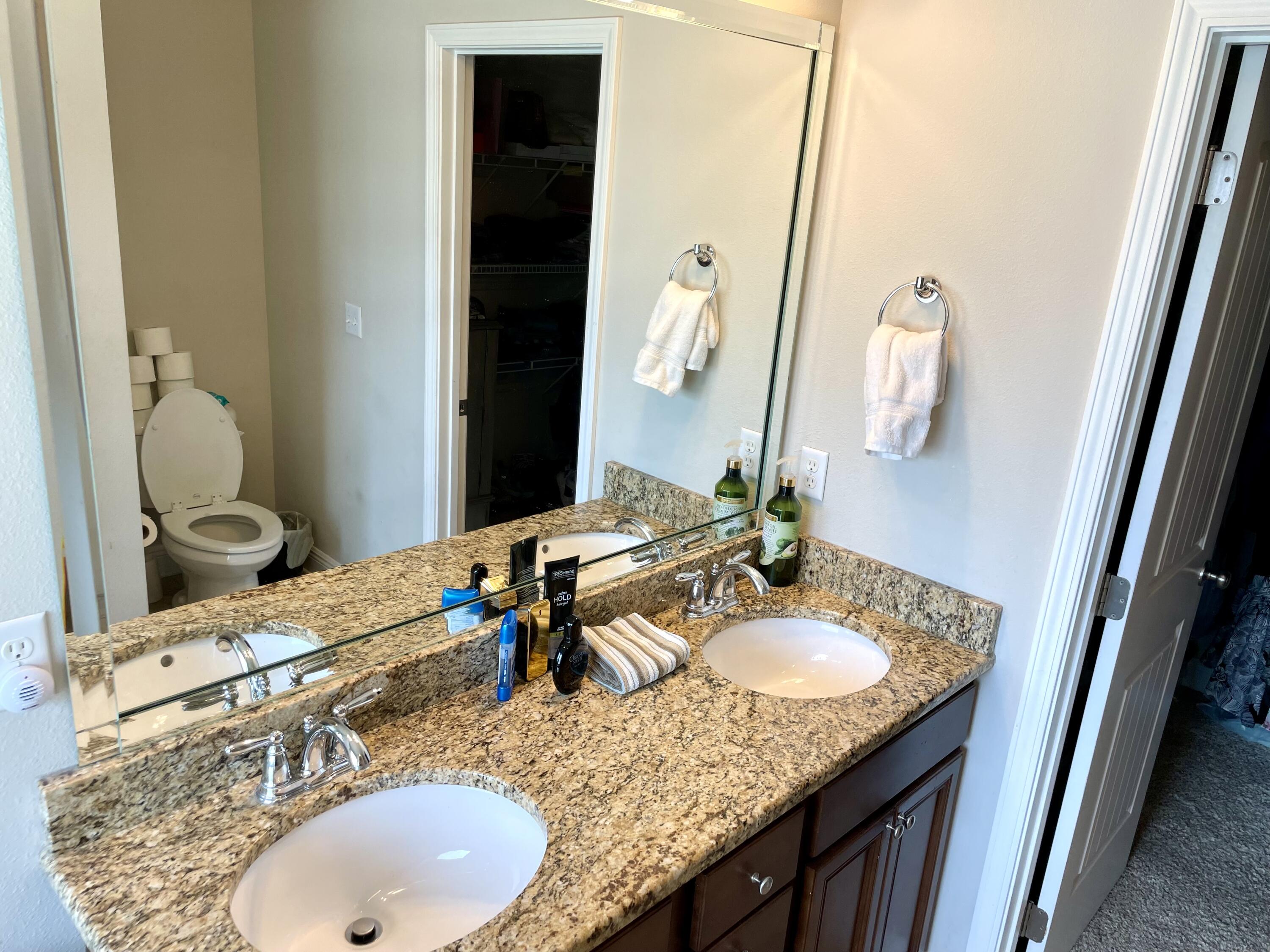 46 Hemingway Lane Freeport, FL 32439 - Photo 21 of 27 a bathroom with a granite countertop sink and a mirror