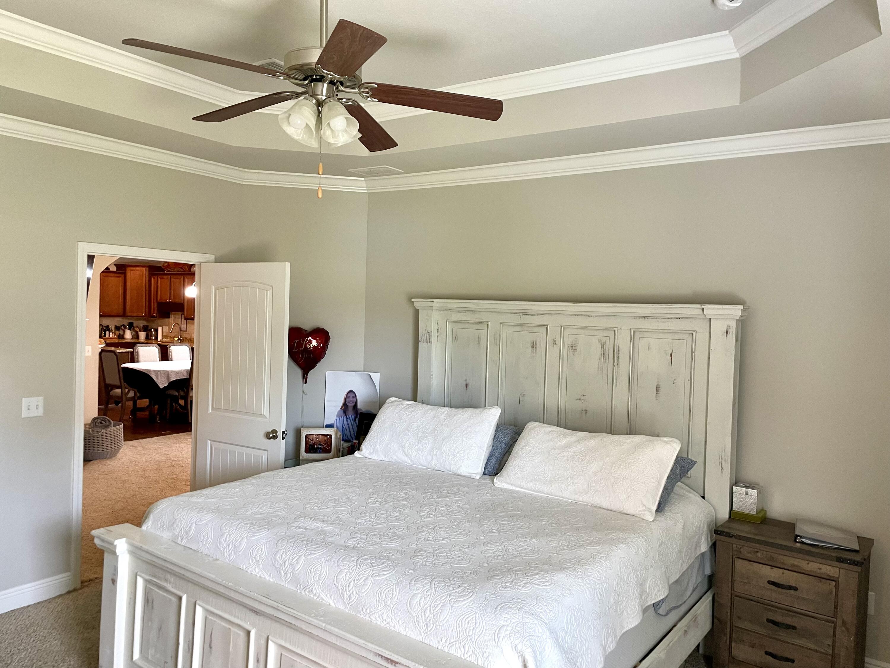 46 Hemingway Lane Freeport, FL 32439 - Photo 22 of 27 a bed room with a bed and a ceiling fan