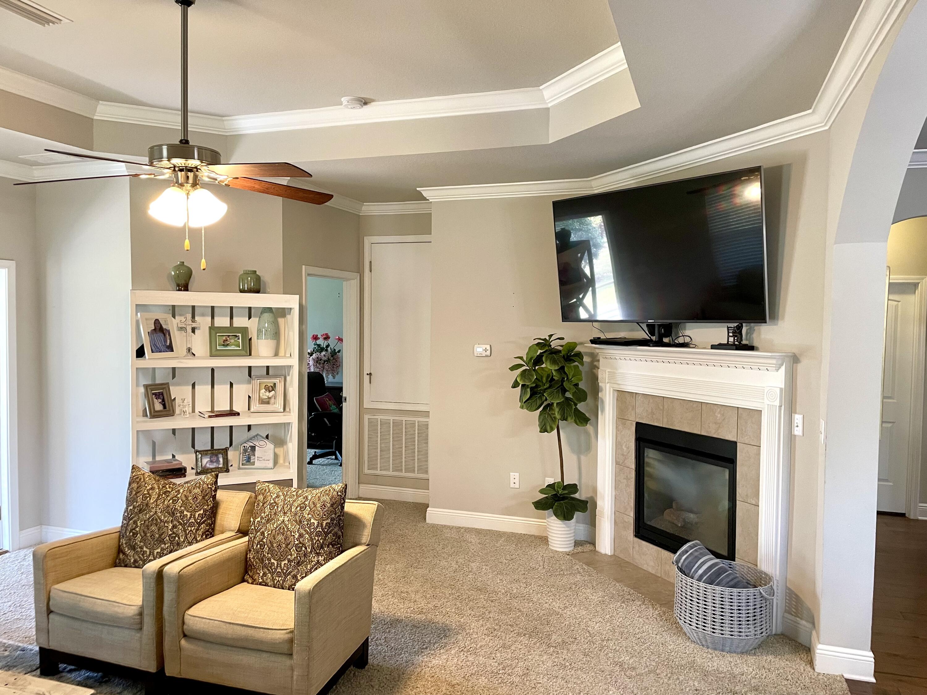 46 Hemingway Lane Freeport, FL 32439 - Photo 24 of 27 a living room with furniture a flat screen tv and a fireplace