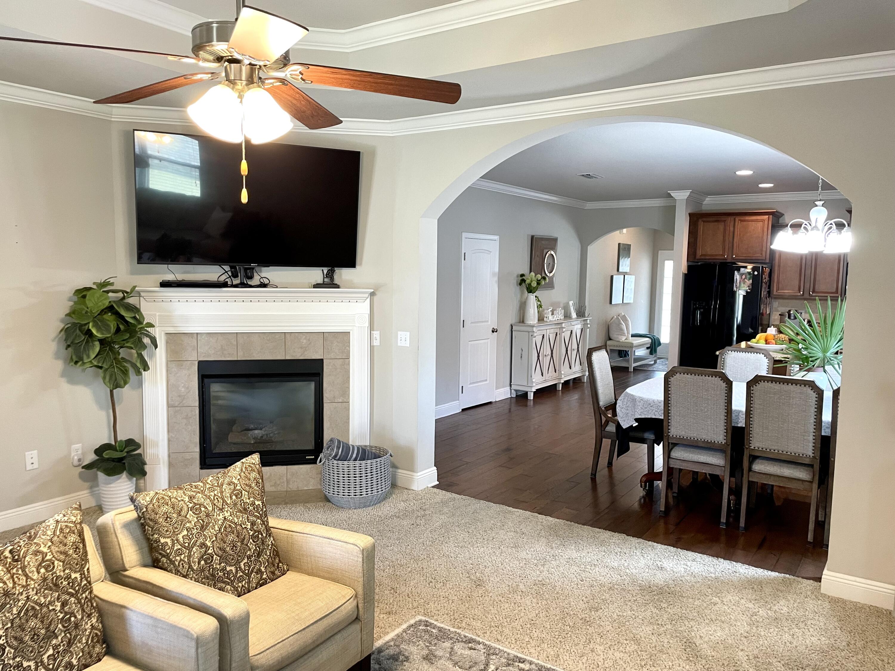 46 Hemingway Lane Freeport, FL 32439 - Photo 25 of 27 a living room with furniture a flat screen tv and a fireplace