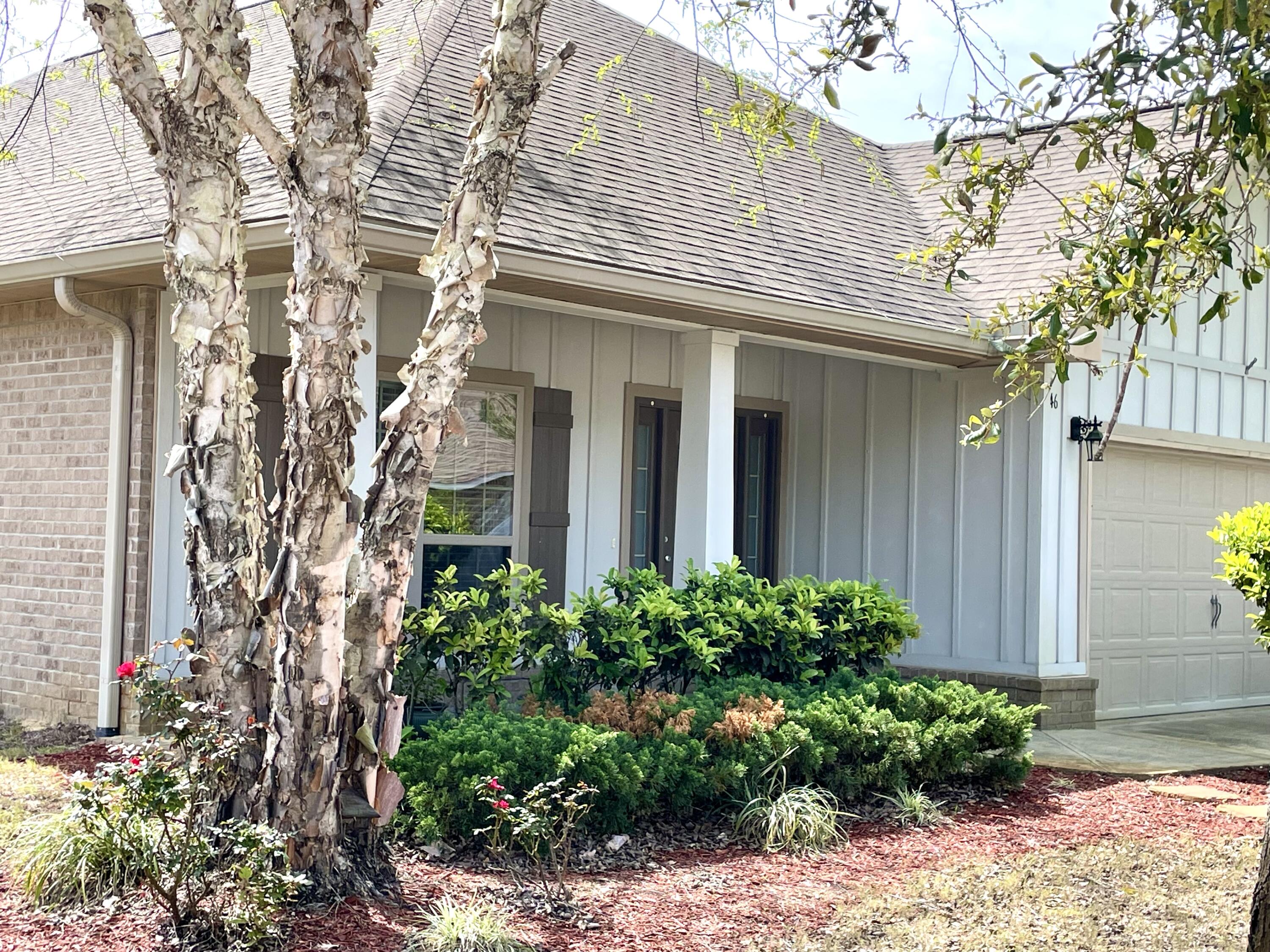 46 Hemingway Lane Freeport, FL 32439 - Photo 5 of 27 a front view of a house with a garden