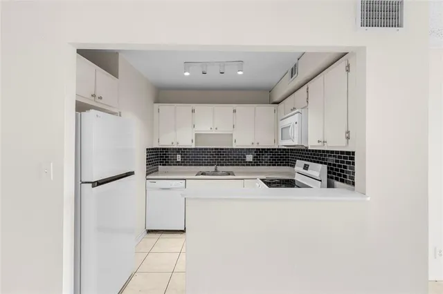 a kitchen with white cabinets