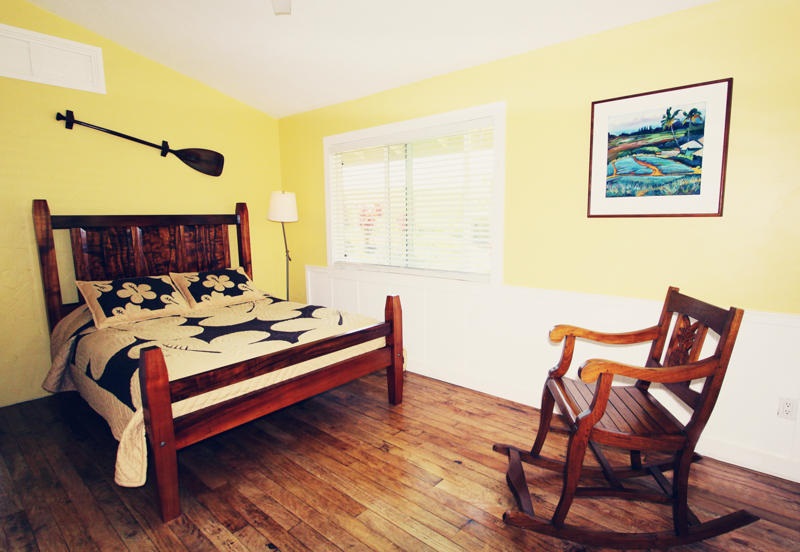 1061 Kokomo Road Haiku, HI 96708 - Photo 25 of 30 a bed room with a bed and chair