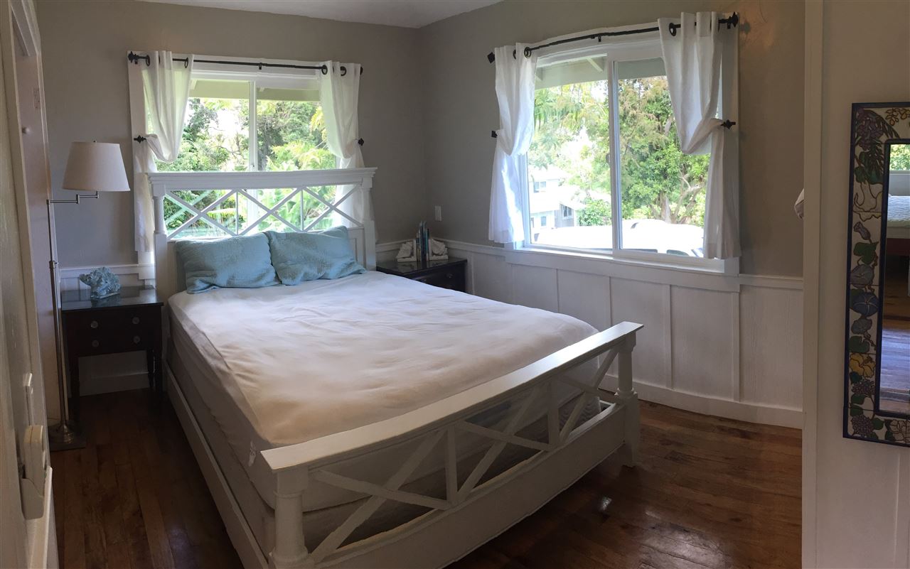 1061 Kokomo Road Haiku, HI 96708 - Photo 26 of 30 a bed sitting in a bedroom next to a window