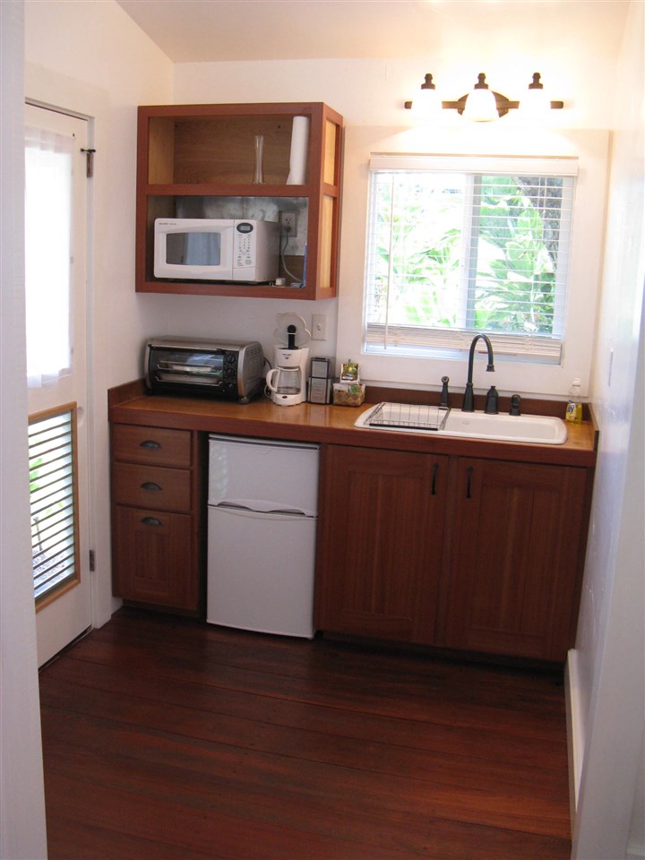 1061 Kokomo Road Haiku, HI 96708 - Photo 29 of 30 a kitchen with a sink and cabinets