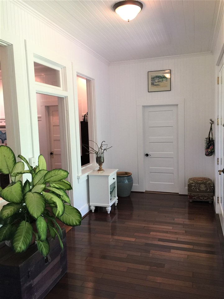 1061 Kokomo Road Haiku, HI 96708 - Photo 3 of 30 a living room with furniture and a potted plant