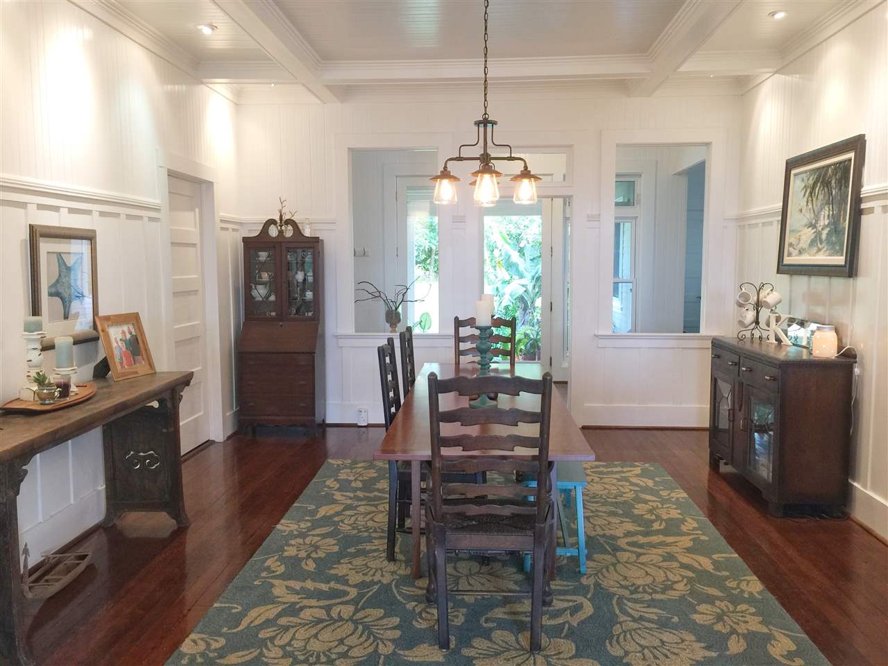 1061 Kokomo Road Haiku, HI 96708 - Photo 6 of 30 a living room with furniture and a chandelier
