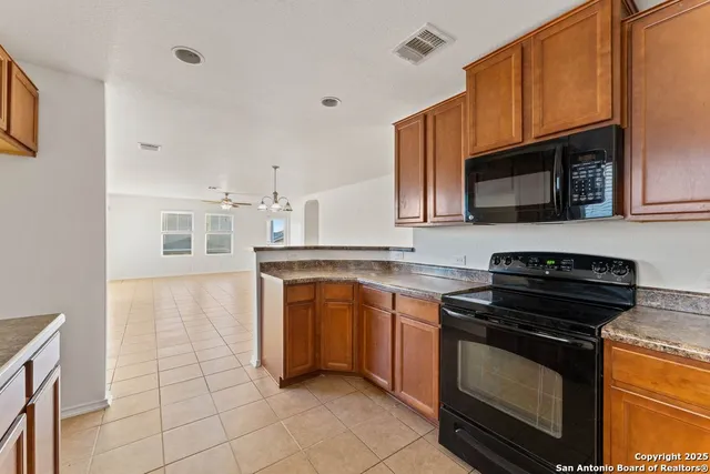 a kitchen with stainless steel appliances granite countertop a stove microwave and sink