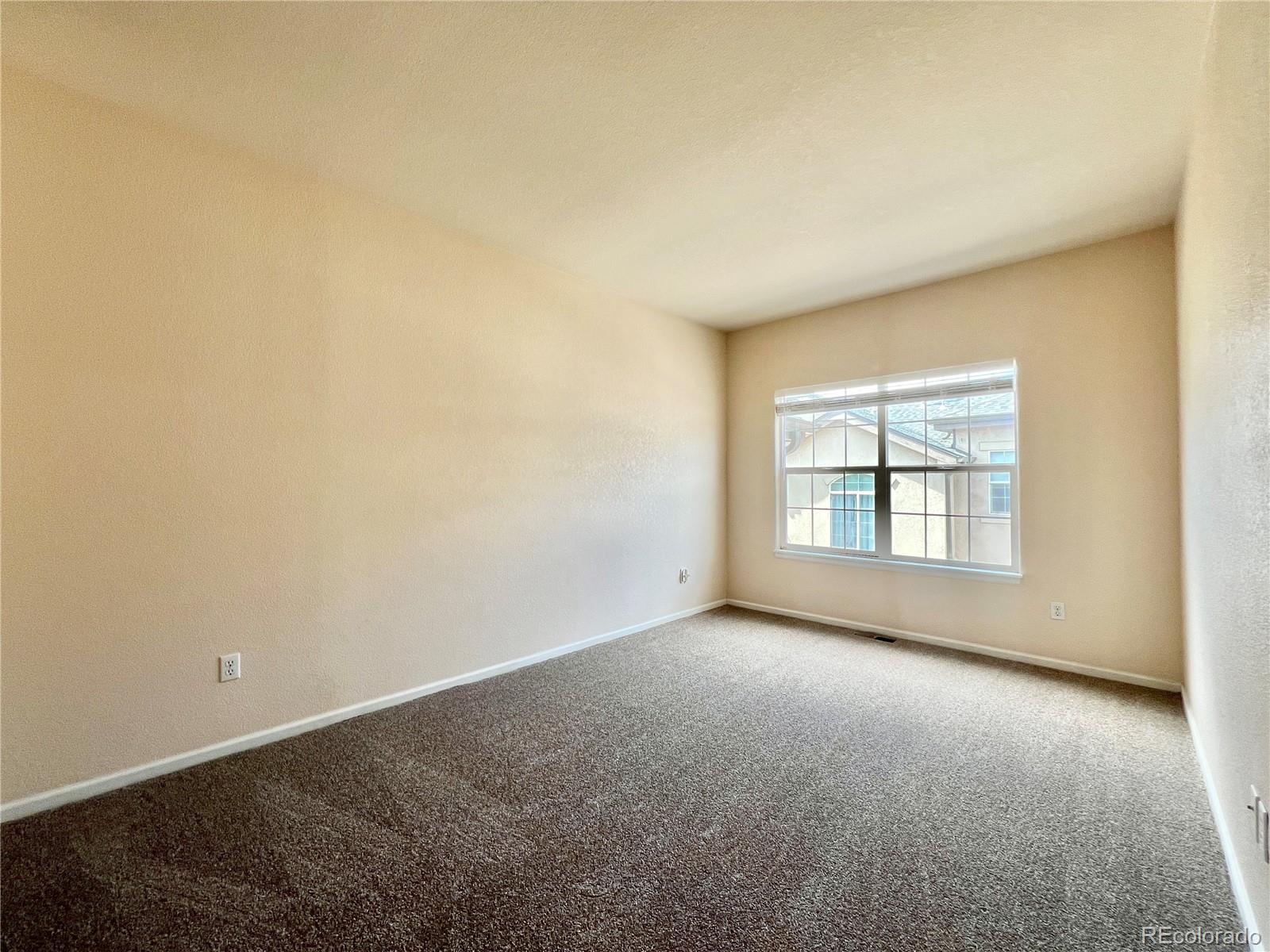 1385 South Chambers Road, Unit 102 Aurora, CO 80017 - Photo 16 of 20 an empty room with a empty space and windows