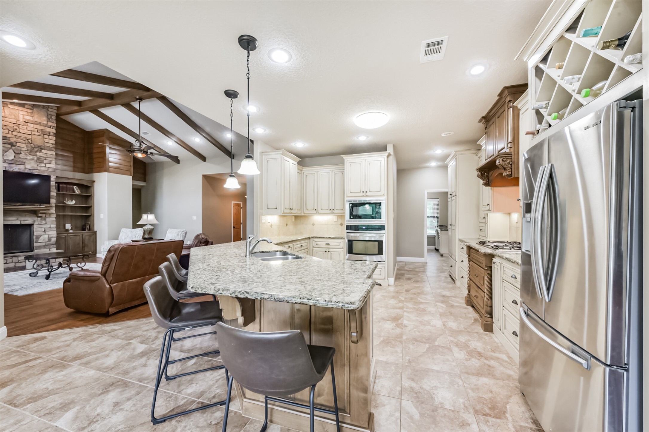 46 Deer Ridge Cleveland, TX 77327 - Photo 11 of 40 a kitchen with stainless steel appliances refrigerator dining table and chairs