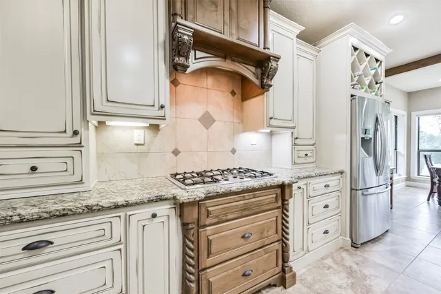 a kitchen with granite countertop white cabinets and white appliances