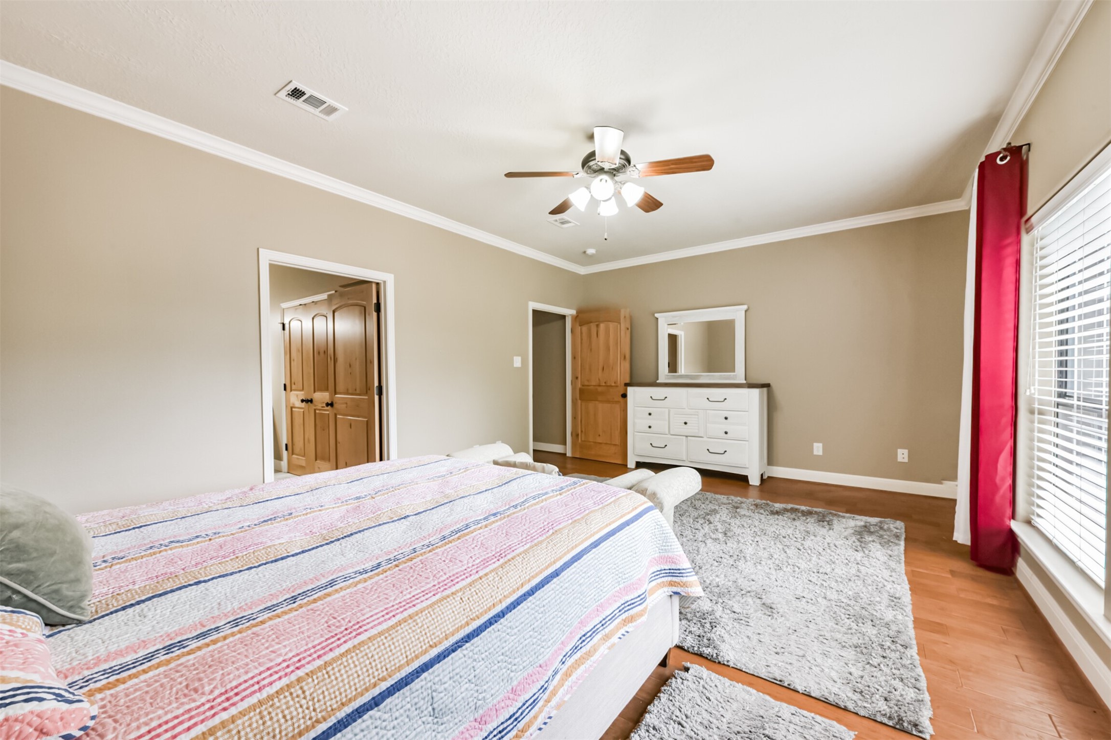 46 Deer Ridge Cleveland, TX 77327 - Photo 18 of 40 a spacious bedroom with a bed and a chandelier