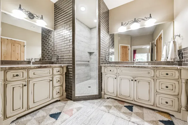 a bathroom with a sink vanity and mirror