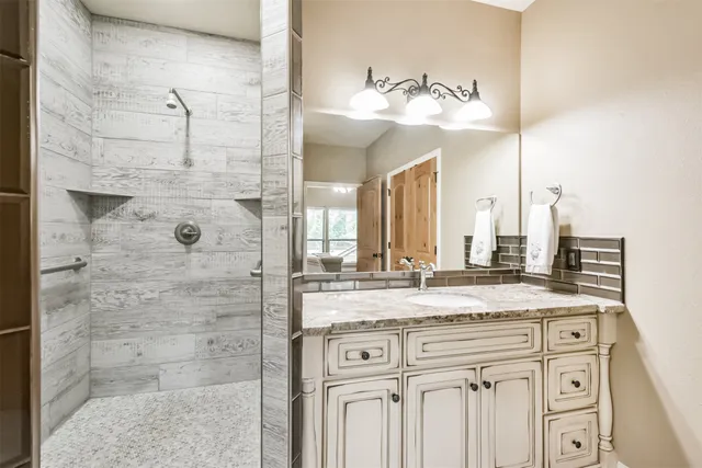 a bathroom with a sink vanity and a mirror