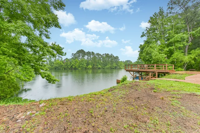 a view of a lake with a garden and deck