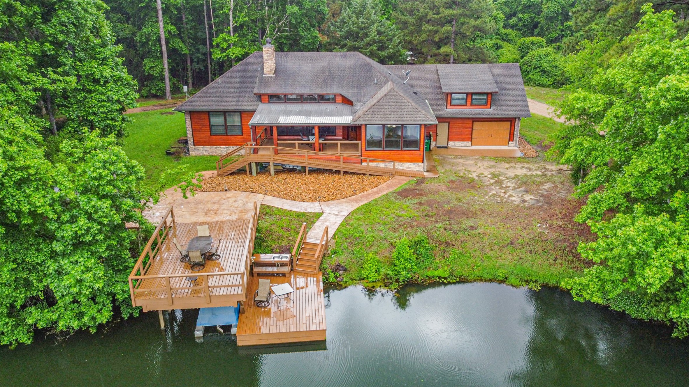 46 Deer Ridge Cleveland, TX 77327 - Photo 3 of 40 an aerial view of a house with swimming pool patio and lake view