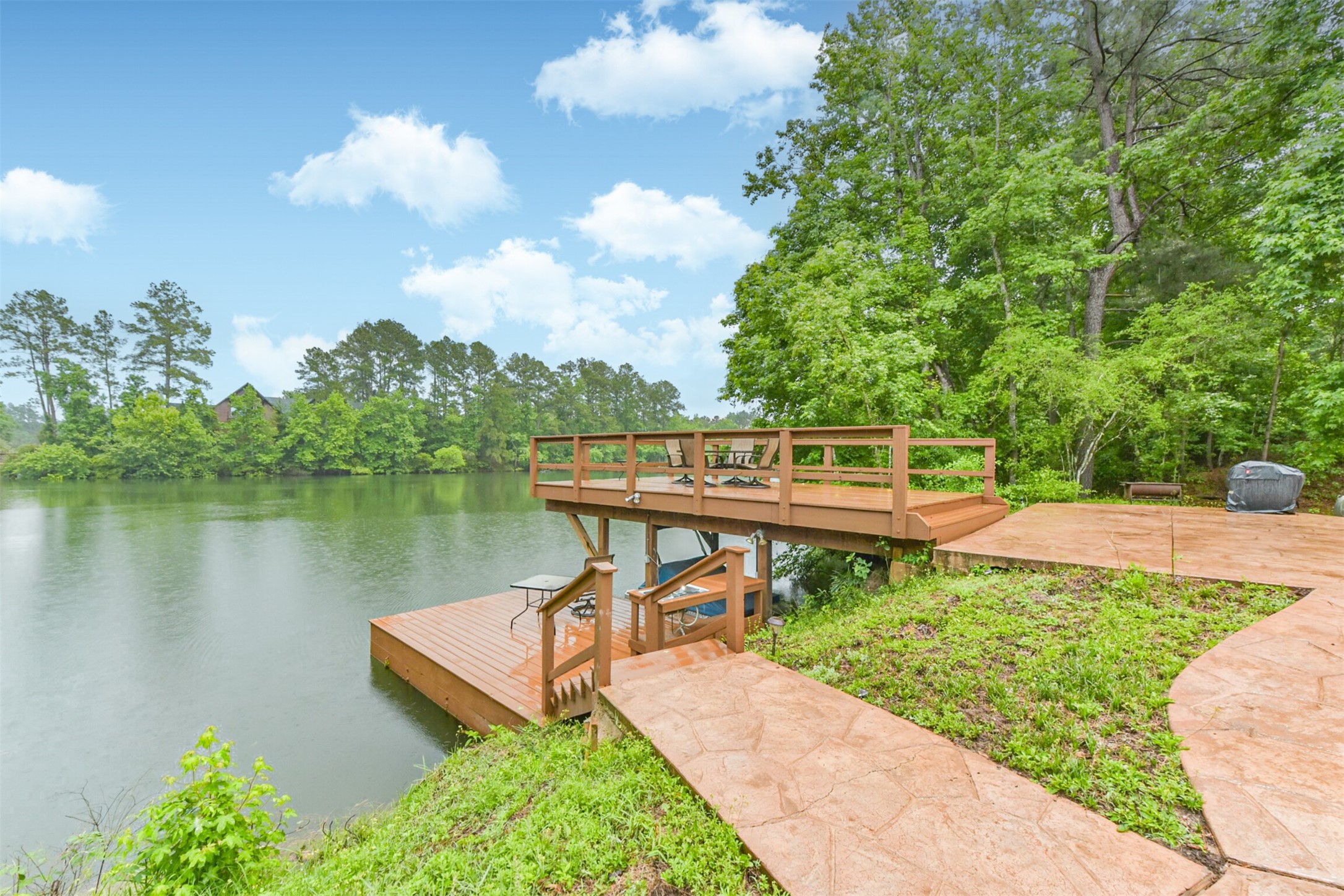 46 Deer Ridge Cleveland, TX 77327 - Photo 31 of 40 a view of a lake with a garden and deck