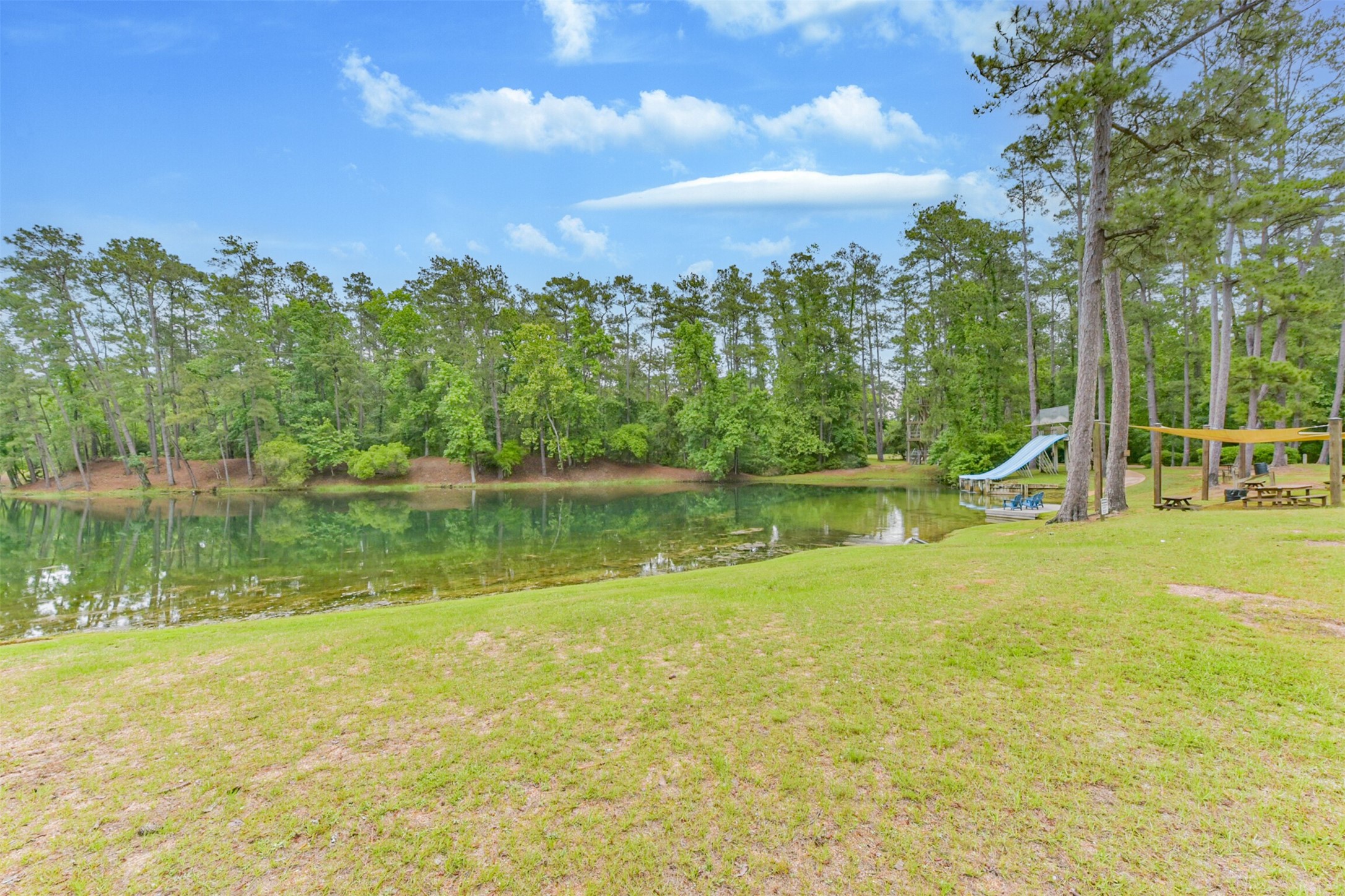 46 Deer Ridge Cleveland, TX 77327 - Photo 38 of 40 a view of a lake with a house in the background