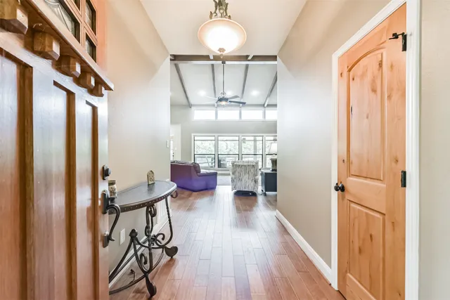 a view of a hallway with couches and chandelier