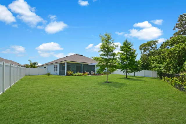 a view of a big yard with a house in the background