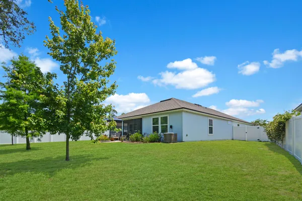 a view of a house with a backyard