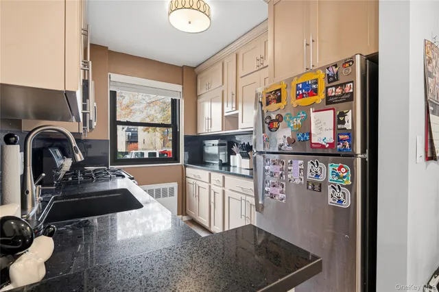 a kitchen with stainless steel appliances granite countertop a refrigerator and a stove