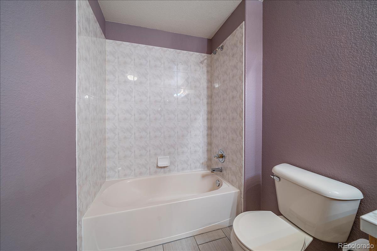 6310 Trailhead Road Highlands Ranch, CO 80130 - Photo 18 of 23 a white toilet and tub sitting next to a bathroom sink