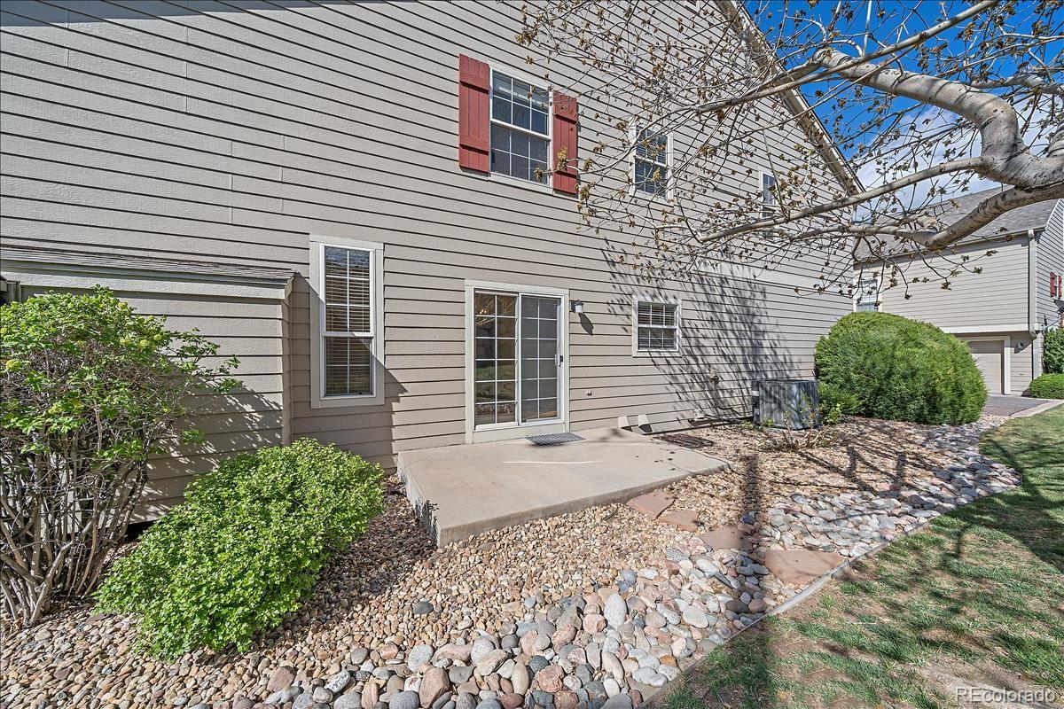 6310 Trailhead Road Highlands Ranch, CO 80130 - Photo 22 of 23 a front view of a house with a yard and garage