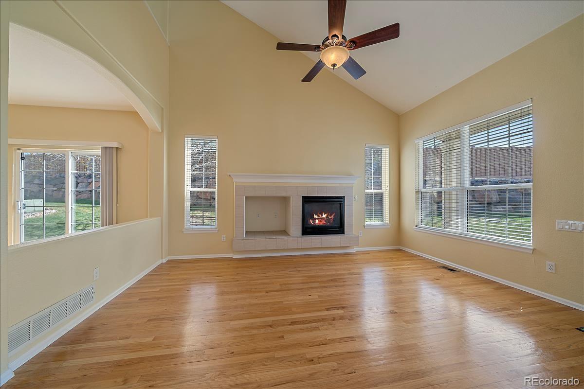 6310 Trailhead Road Highlands Ranch, CO 80130 - Photo 4 of 23 a view of an empty room with wooden floor fireplace and a window