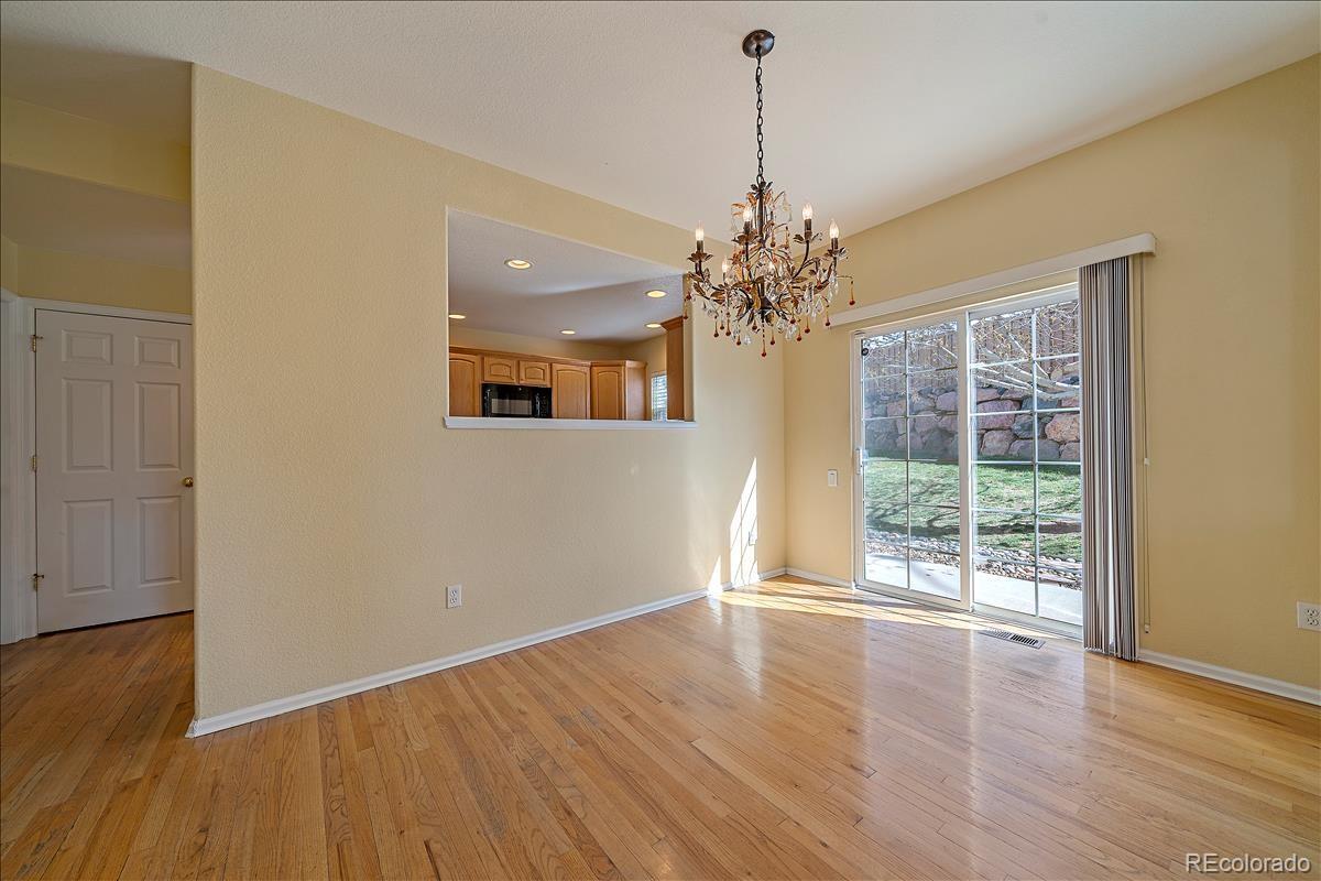 6310 Trailhead Road Highlands Ranch, CO 80130 - Photo 5 of 23 a view of livingroom with chandelier and wooden floor