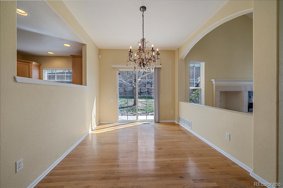 6310 Trailhead Road Highlands Ranch, CO 80130 - Photo 6 of 23 a view of an empty room with window and wooden floor