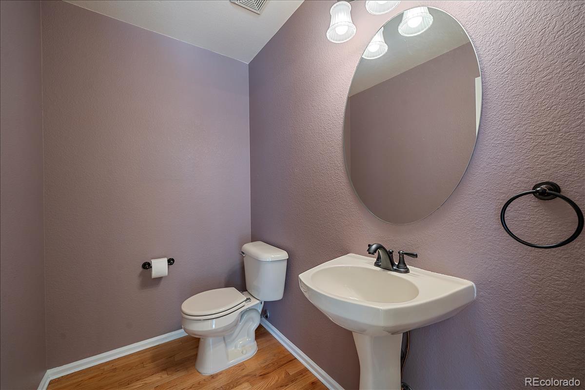 6310 Trailhead Road Highlands Ranch, CO 80130 - Photo 9 of 23 a bathroom with a toilet sink and mirror